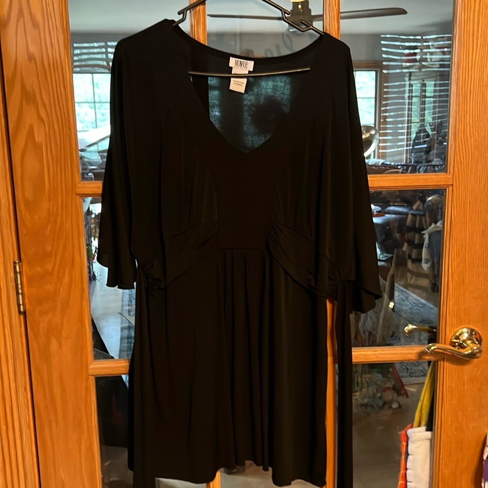 Black v neck blouse with tie backs and gathered at waist